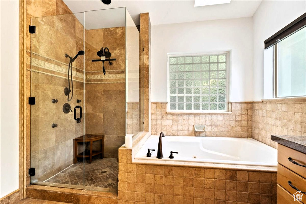 Bathroom featuring a bath and a shower stall