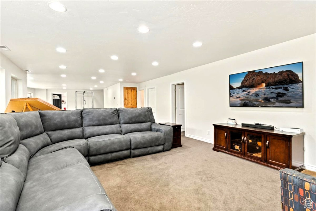 Living area featuring recessed lighting, light colored carpet, and baseboards