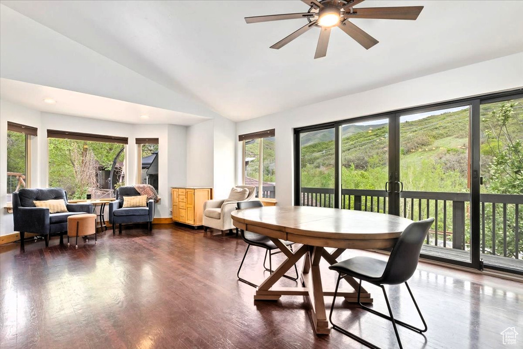 Dining area with a ceiling fan, wood finished floors, baseboards, high vaulted ceiling, and recessed lighting