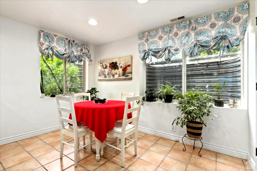 Dining area featuring baseboards, tile patterned floors, and recessed lighting