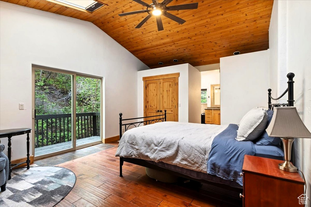 Bedroom featuring high vaulted ceiling, access to outside, wood ceiling, wood finished floors, and baseboards