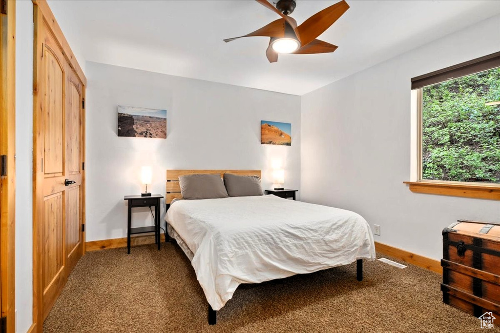 Bedroom with baseboards, carpet floors, and ceiling fan