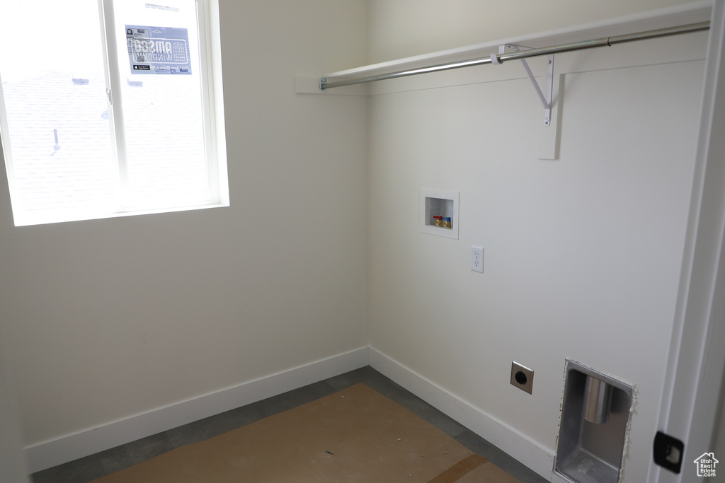 Washroom featuring hookup for a washing machine, electric dryer hookup, and baseboards