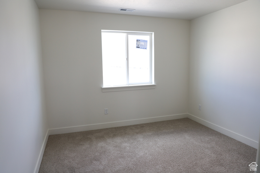 Carpeted empty room with baseboards