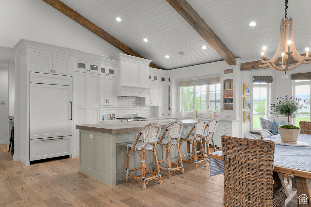 Kitchen featuring a chandelier, decorative backsplash, light wood-style flooring, healthy amount of natural light, and recessed lighting