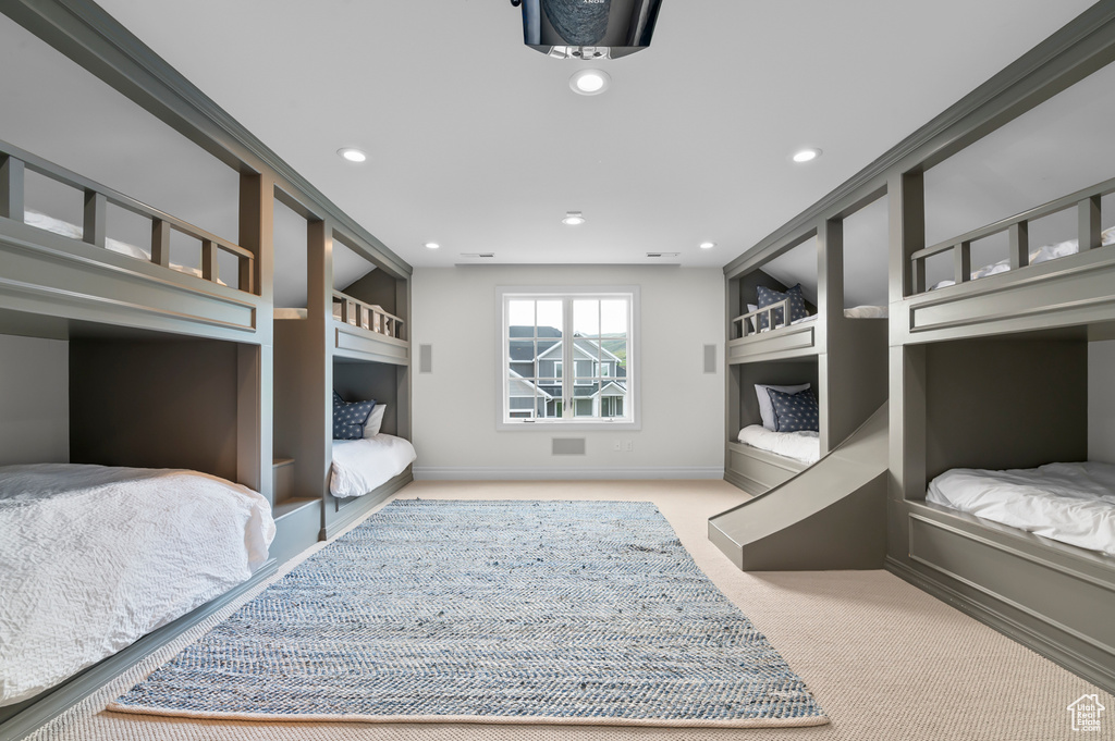 Carpeted bedroom featuring recessed lighting and baseboards