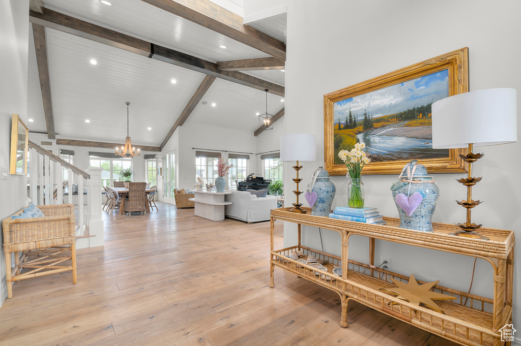 Living room with beamed ceiling, a chandelier, light wood-type flooring, recessed lighting, and high vaulted ceiling