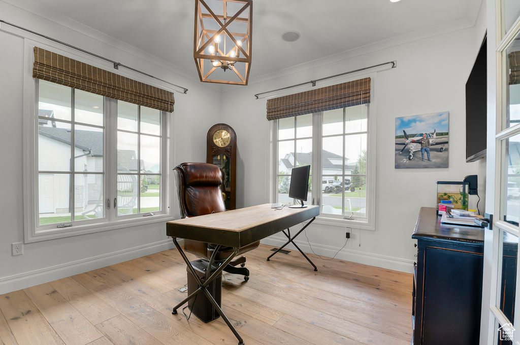Office area with crown molding, healthy amount of natural light, a chandelier, baseboards, and light wood finished floors