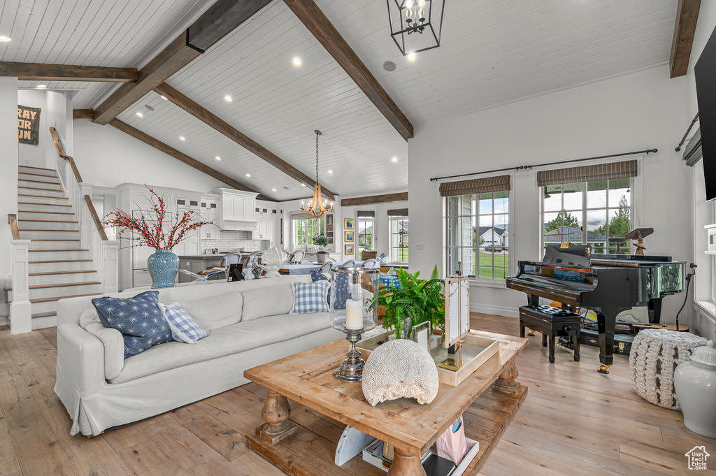 Living room with a chandelier, light wood-type flooring, recessed lighting, stairway, and wood ceiling