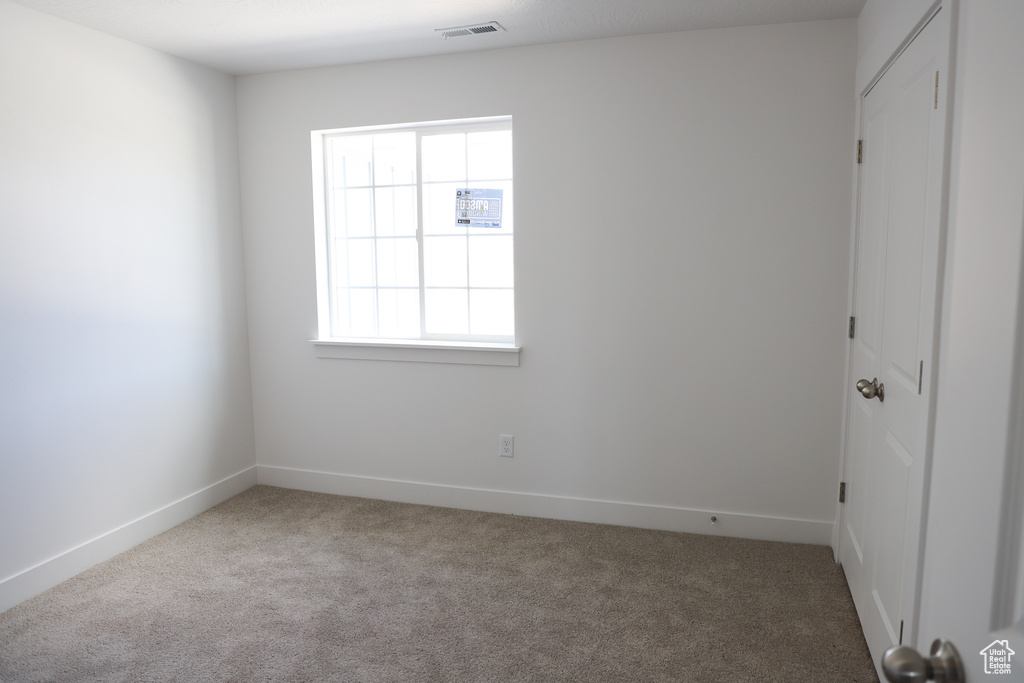 Empty room featuring carpet floors and baseboards