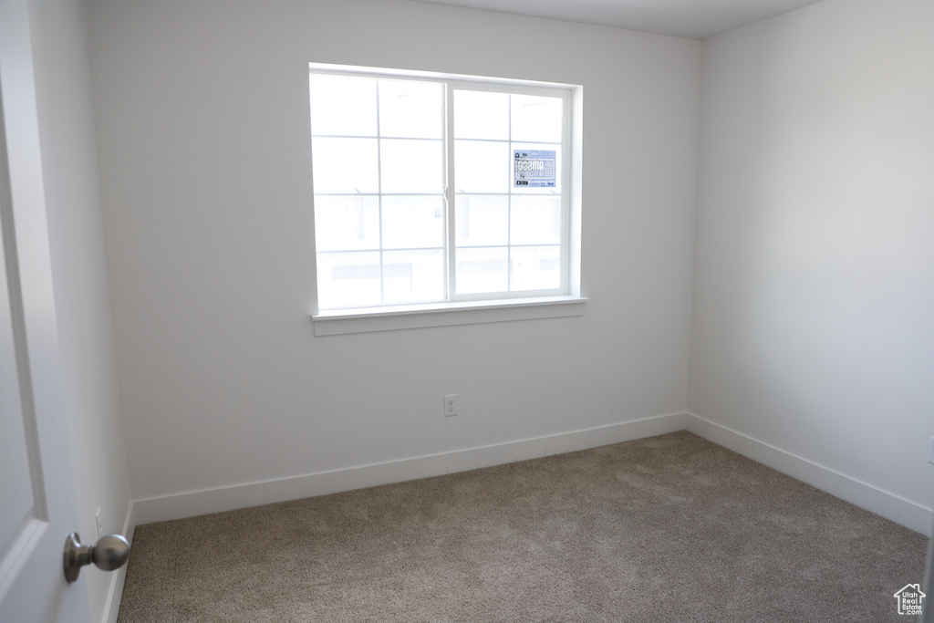 Spare room with carpet floors and baseboards