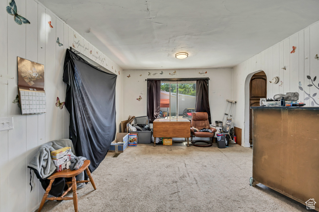 Sitting room featuring arched walkways and carpet
