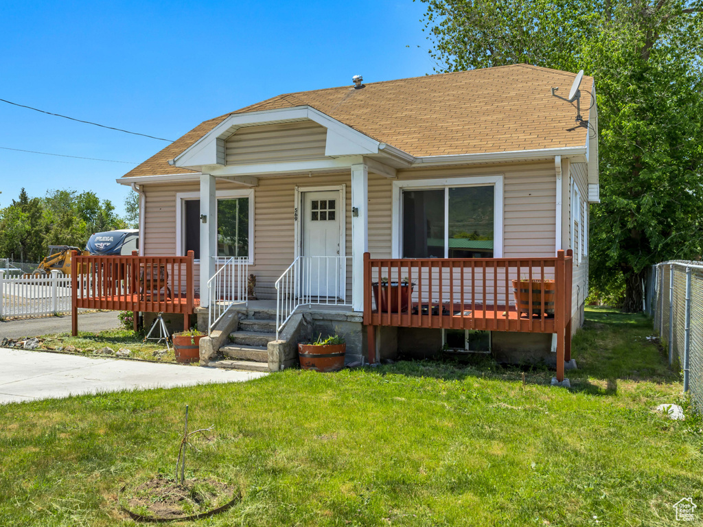 Bungalow with a shingled roof and covered porch