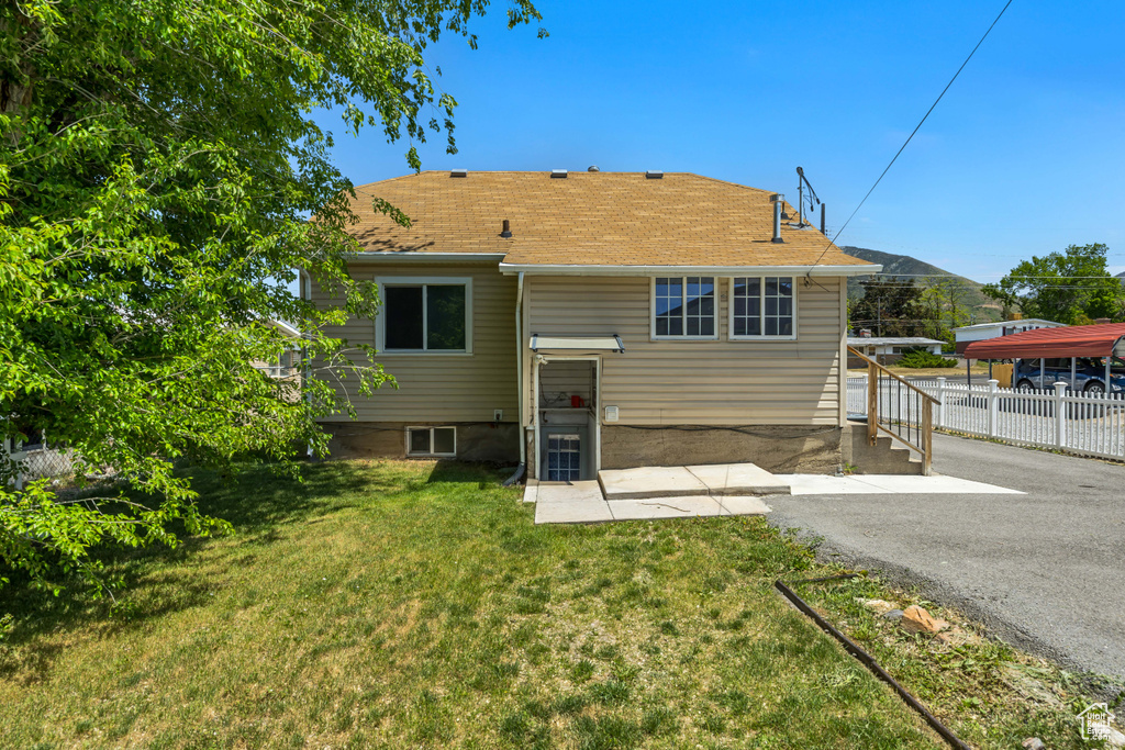 Back of property featuring roof with shingles