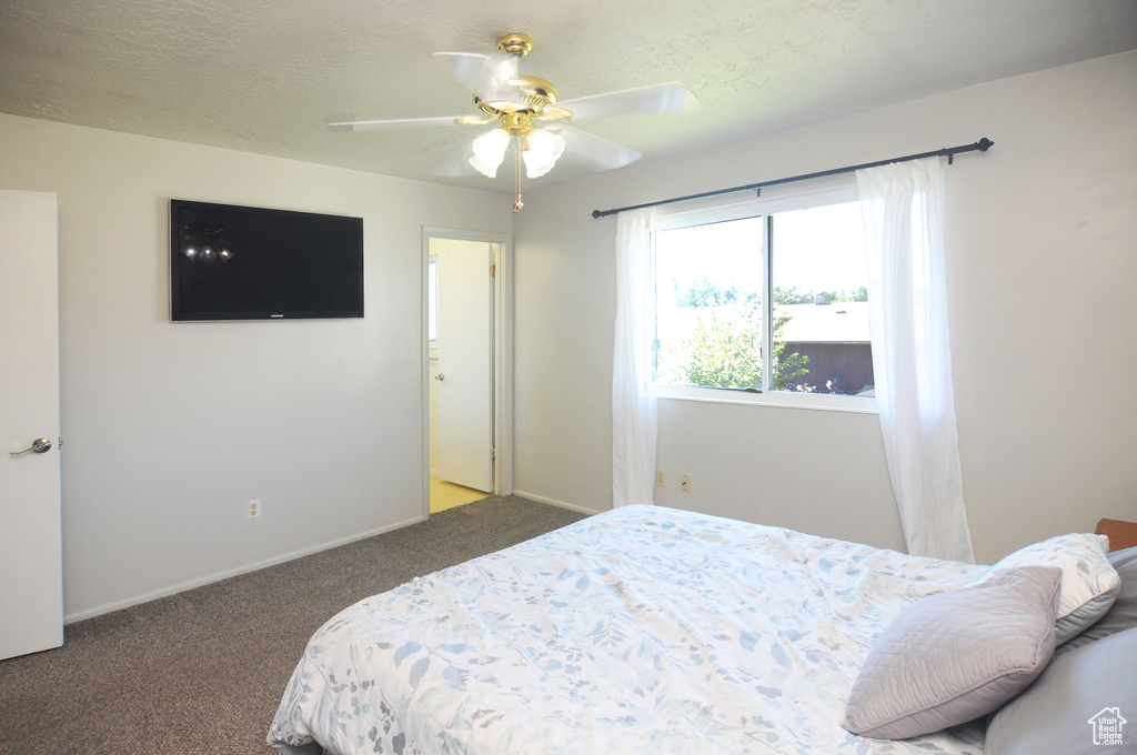 Carpeted bedroom with baseboards and ceiling fan