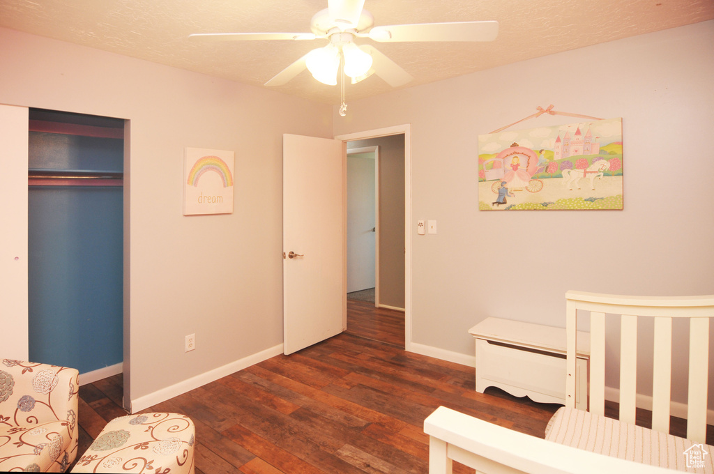 Bedroom with wood finished floors, baseboards, ceiling fan, and a closet