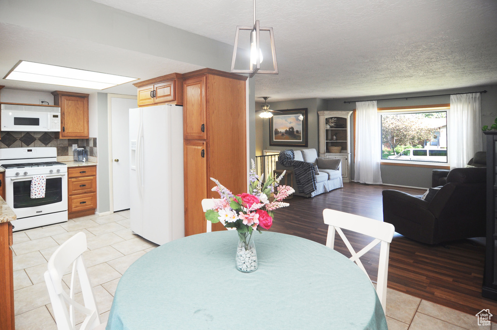 Dining space with light tile patterned flooring and a textured ceiling