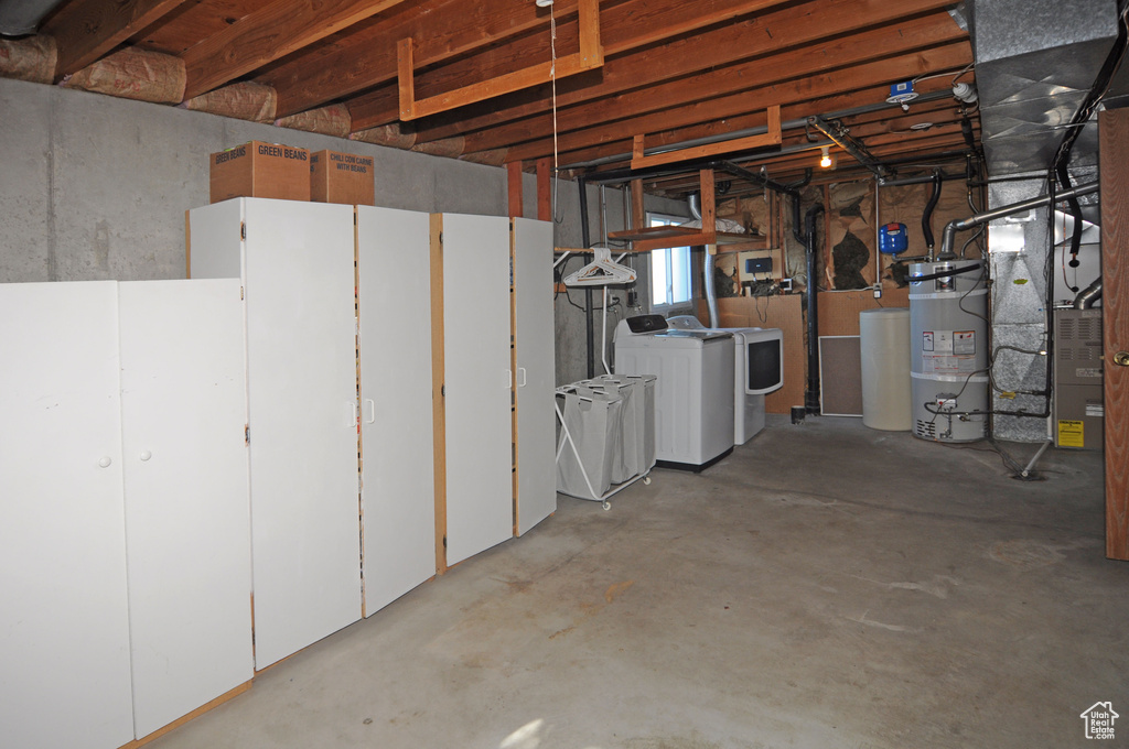 Unfinished below grade area with strapped water heater, washing machine and dryer, and heating unit