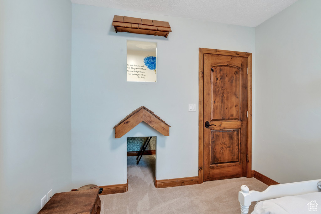 Bedroom with carpet floors and baseboards