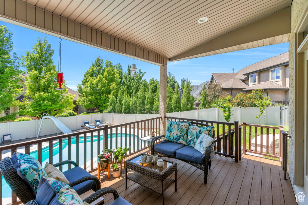Wooden terrace with outdoor lounge area and a fenced backyard