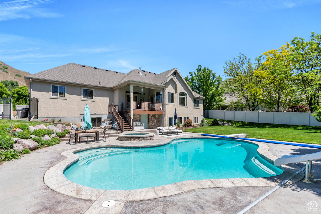 View of swimming pool with stairway, a patio area, and a deck