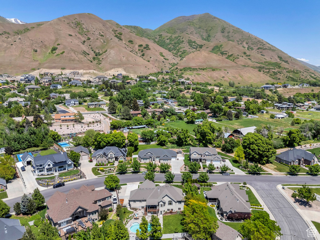 Aerial perspective of suburban area featuring a mountainous background