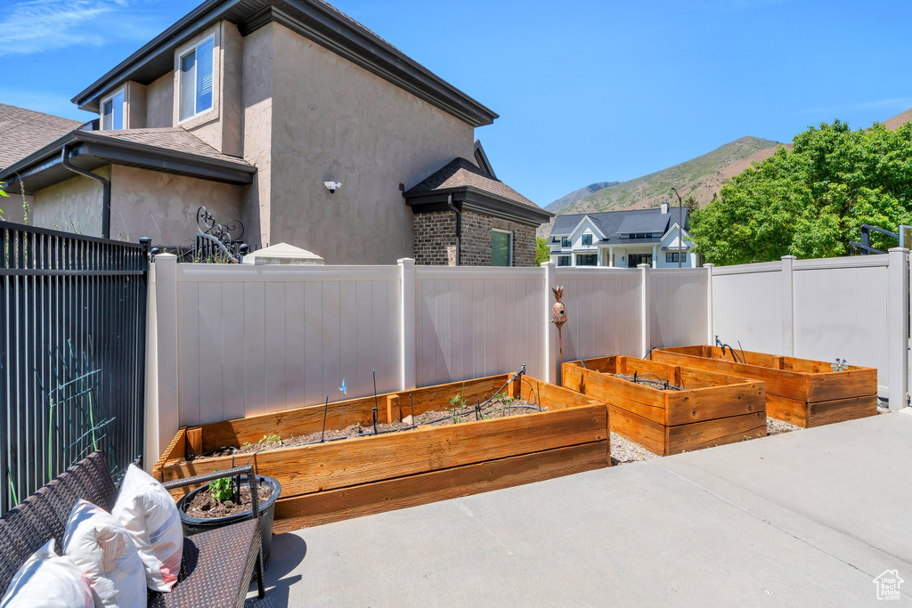 View of patio featuring a vegetable garden and a mountain view