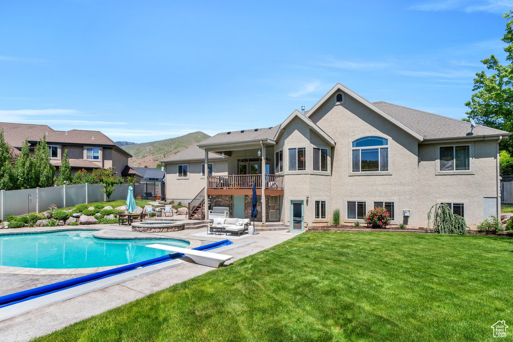 View of swimming pool featuring an outdoor hot tub, a patio, stairs, and a mountain view