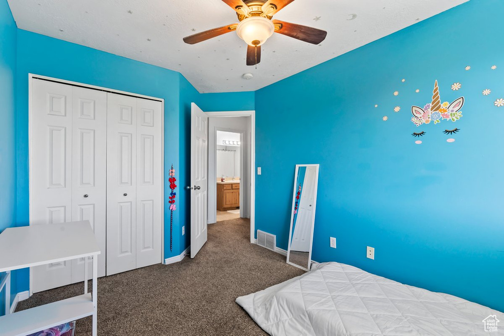 Bedroom with carpet, a closet, baseboards, and a ceiling fan
