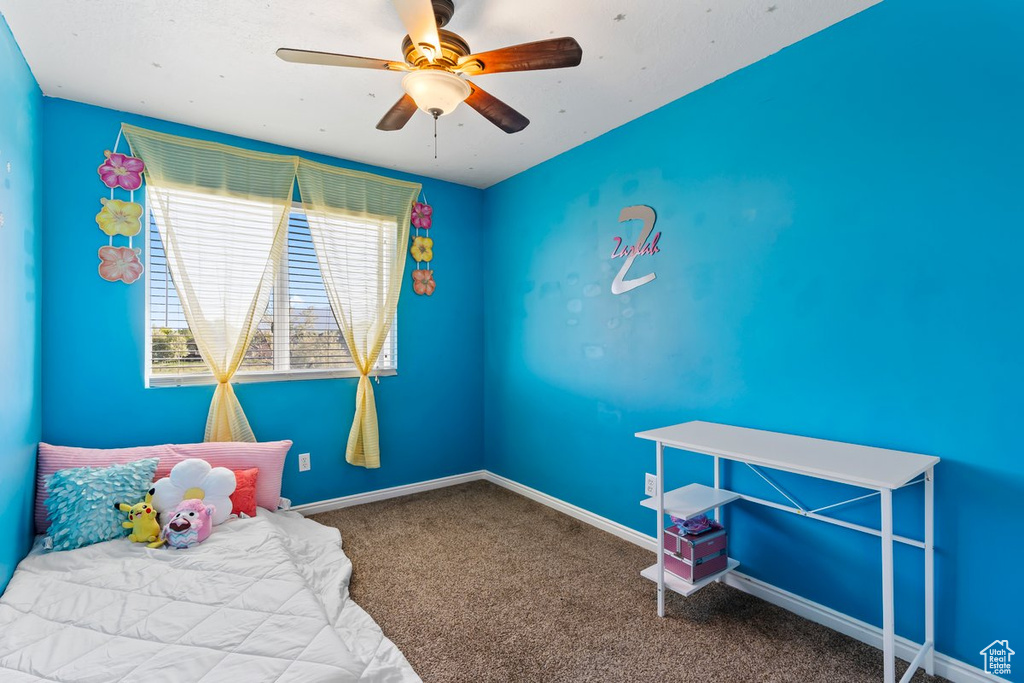 Bedroom featuring carpet flooring, a ceiling fan, and baseboards