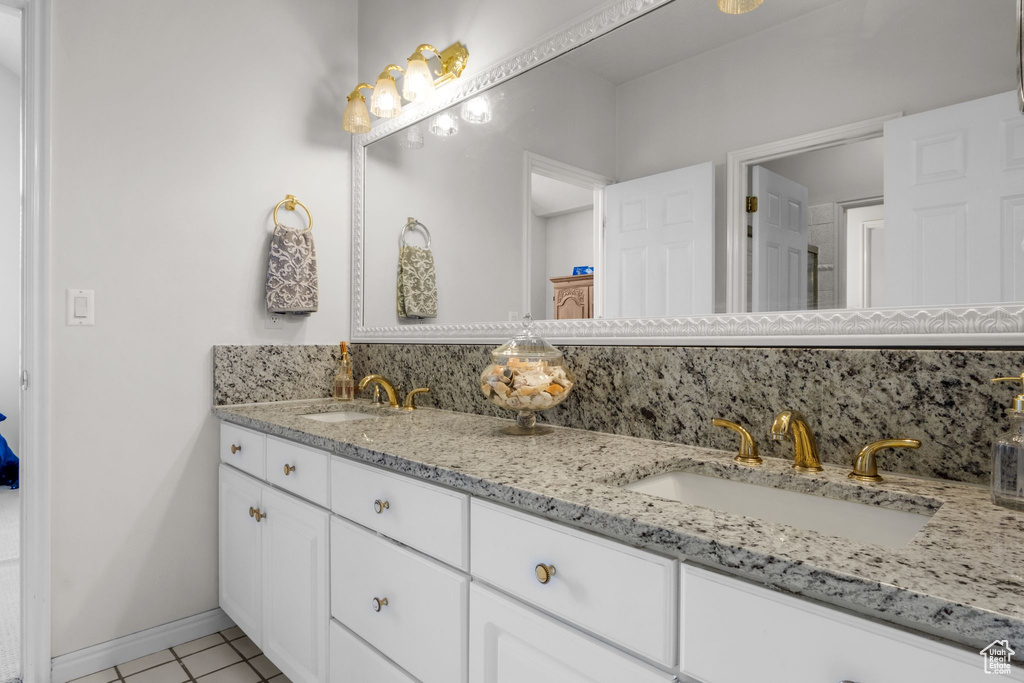 Bathroom featuring double vanity and tile patterned floors