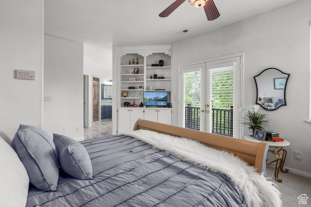Bedroom with access to exterior, light colored carpet, french doors, baseboards, and connected bathroom