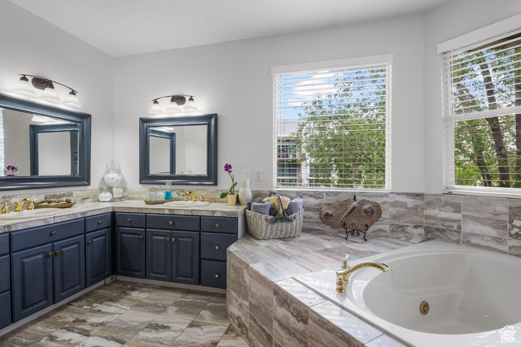Bathroom with double vanity and a whirlpool tub