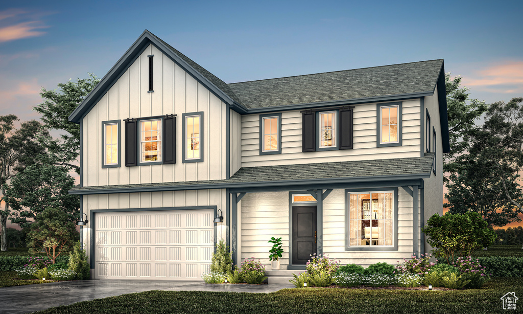 View of front of property with a garage, driveway, board and batten siding, and roof with shingles
