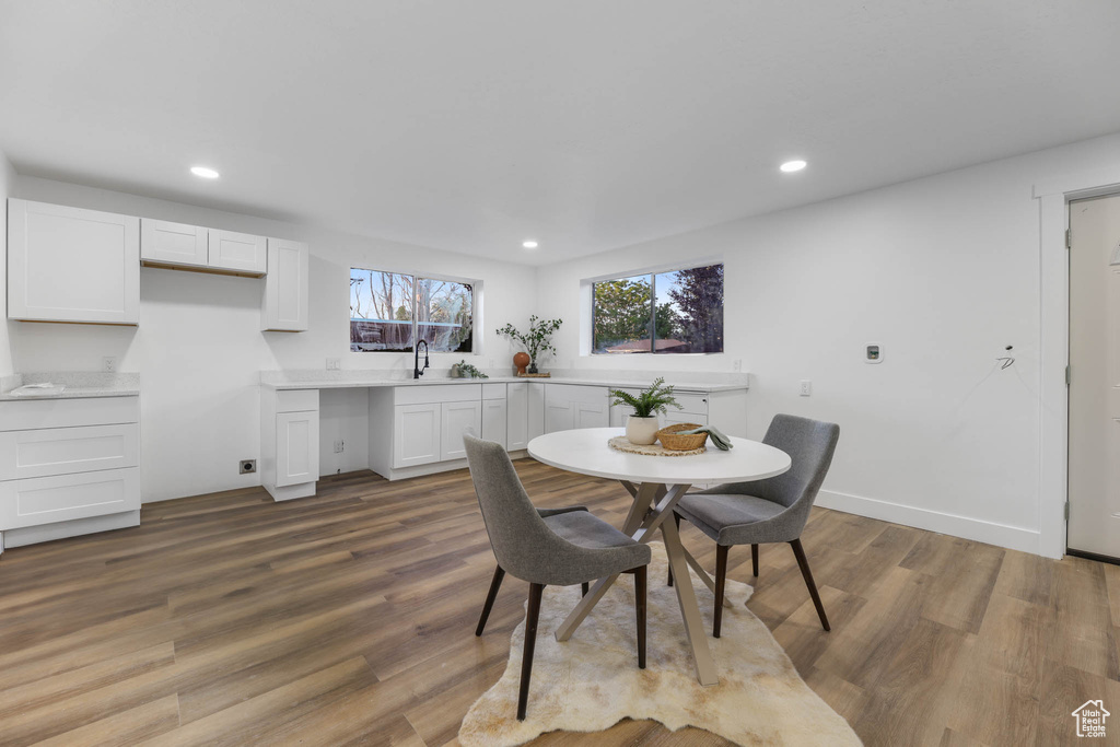 Dining room featuring wood finished floors, recessed lighting, and baseboards