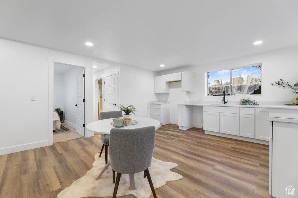 Dining room featuring light wood-style floors, recessed lighting, and baseboards