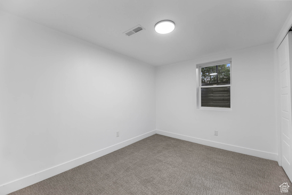 Spare room with carpet and baseboards