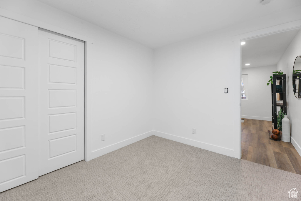 Unfurnished room with recessed lighting, baseboards, and wood finished floors