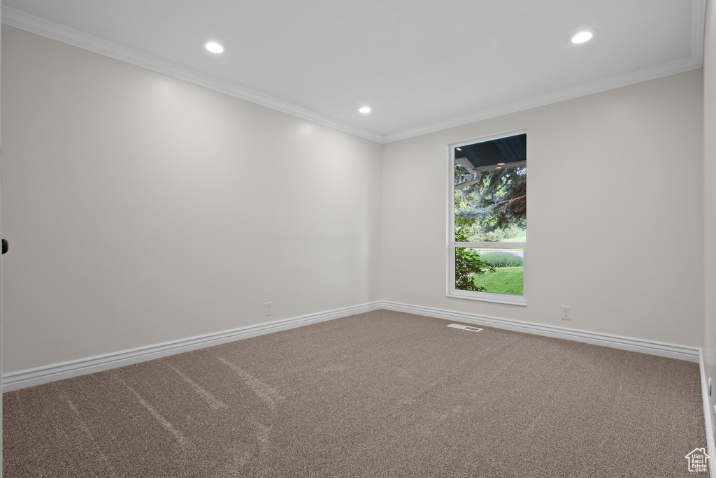 Carpeted empty room with recessed lighting, ornamental molding, and baseboards