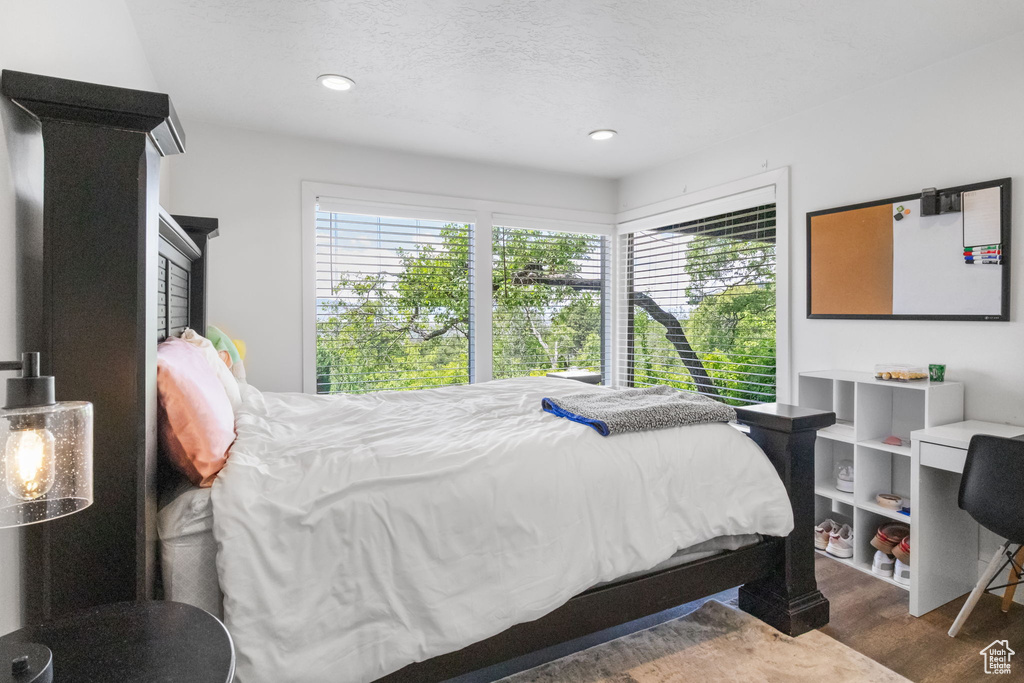 Bedroom featuring wood finished floors, recessed lighting, and a textured ceiling