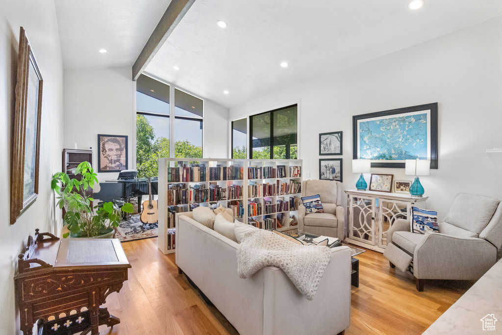 Living area with light wood finished floors and recessed lighting
