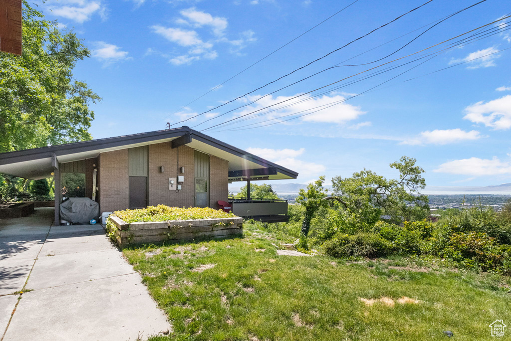 View of home's exterior with brick siding and concrete driveway