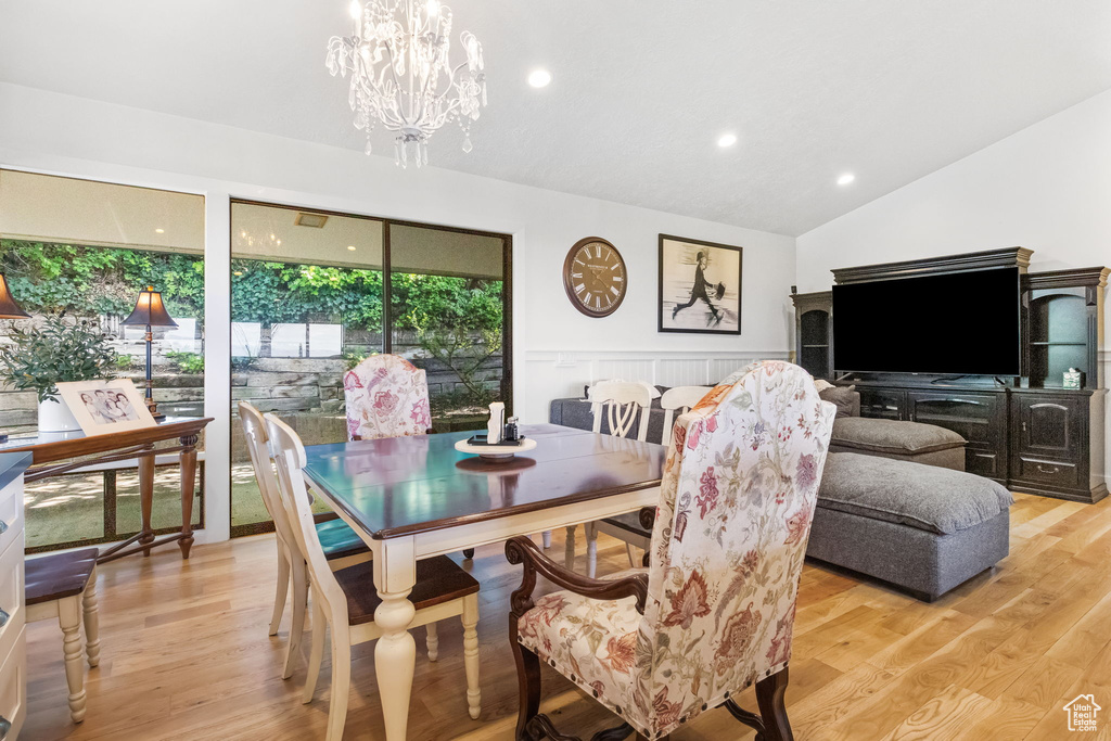 Dining space featuring lofted ceiling, light wood-type flooring, a chandelier, and recessed lighting