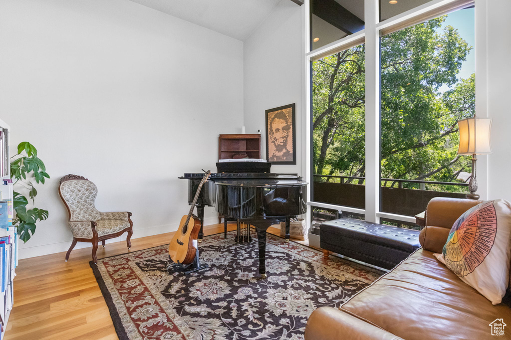 Office space with wood finished floors, baseboards, and vaulted ceiling