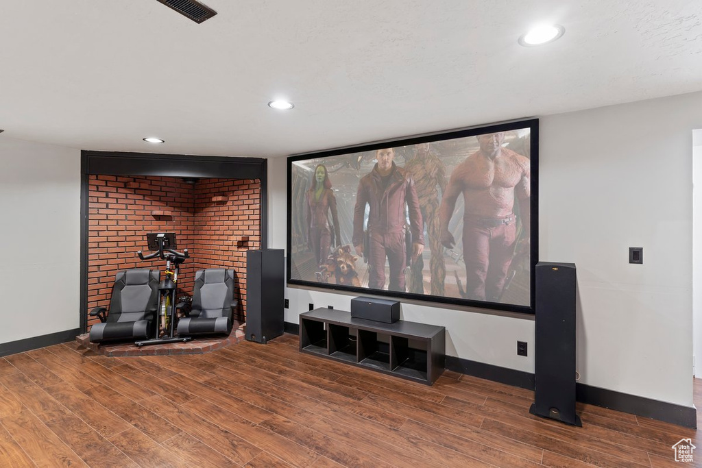 Cinema with wood finished floors, baseboards, and recessed lighting