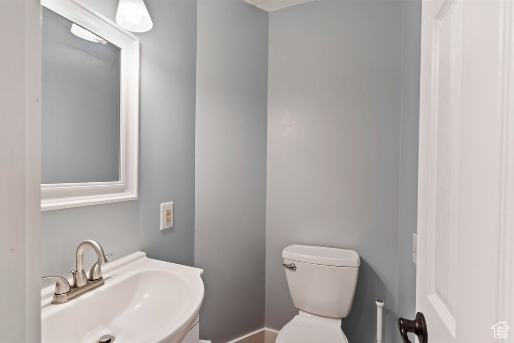 Half bathroom featuring a sink and toilet