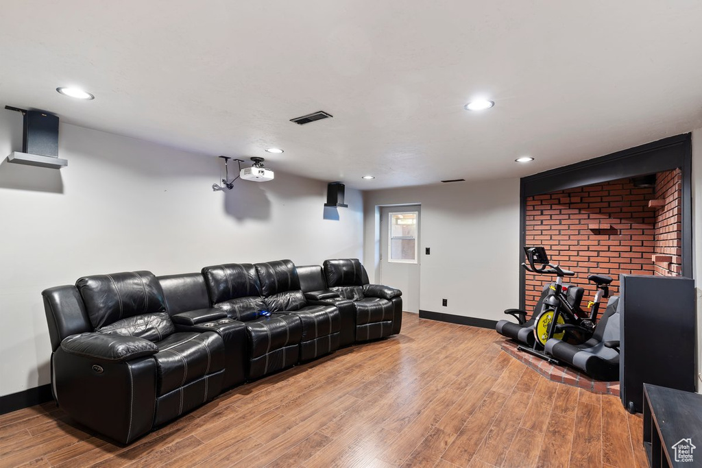 Cinema featuring light wood-style floors, baseboards, and recessed lighting