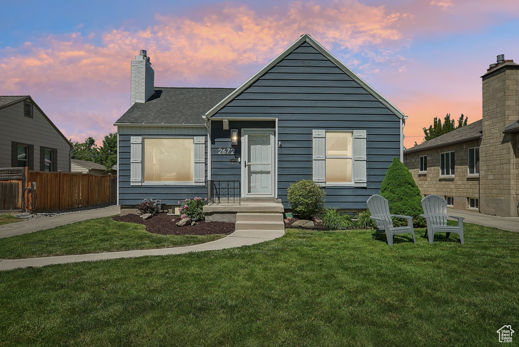 Bungalow with a chimney and a shingled roof
