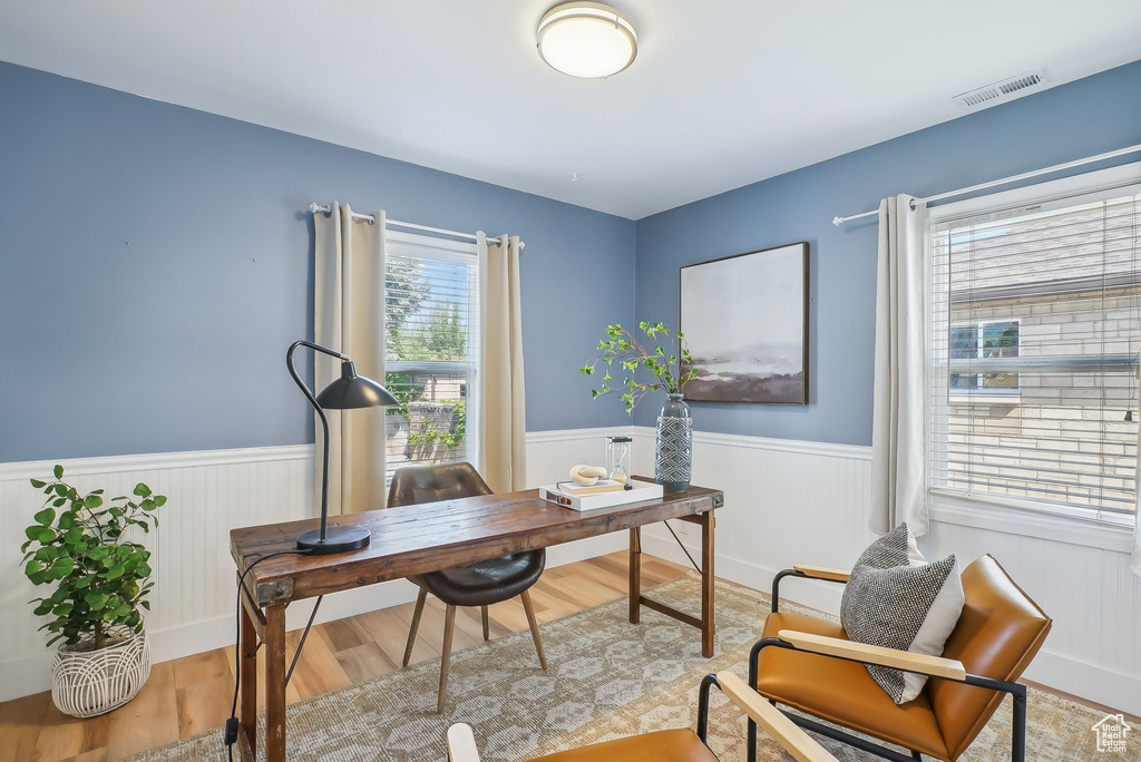 Home office featuring wainscoting and light wood-style floors