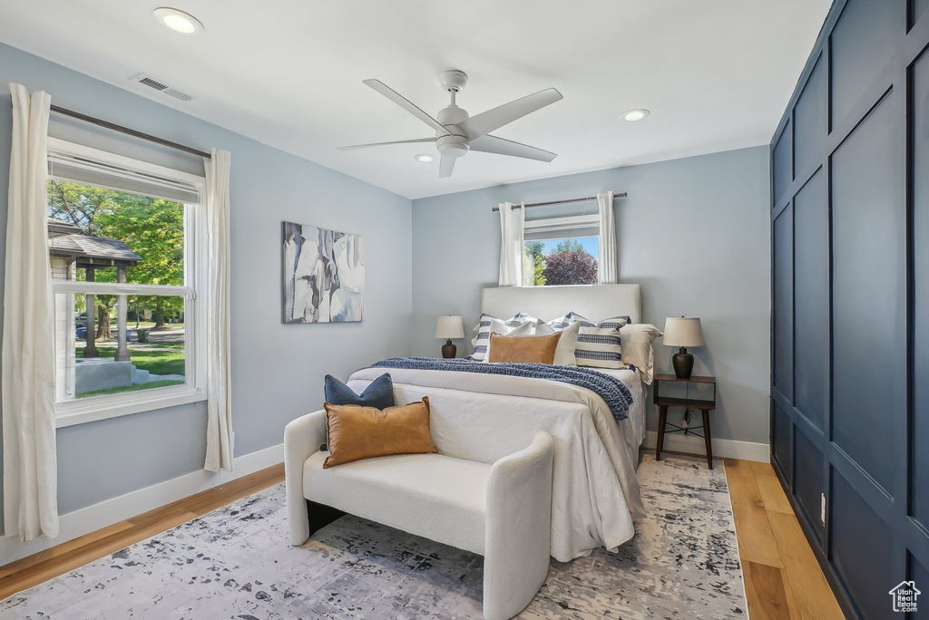 Bedroom with baseboards, light wood-type flooring, recessed lighting, and ceiling fan